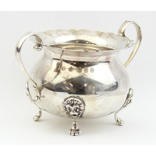 1009E - A vintage silver sugar bowl with frilled edges, lion mask and paw handles, marked Sterling and XRF c... 