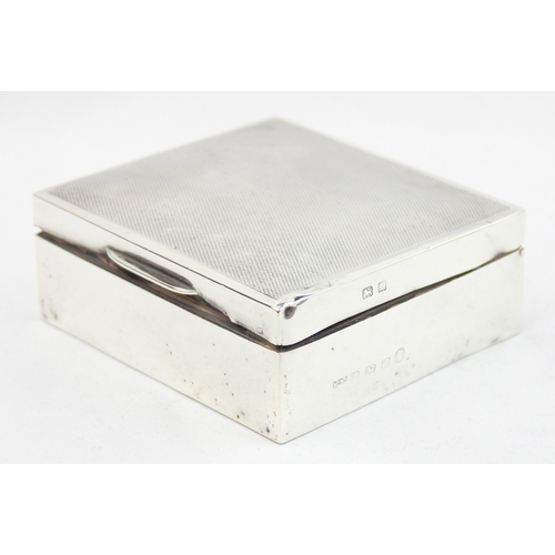 1012 - An Art Deco period silver and wooden lined cigarette box with engine turned top, Birmingham 1935 by ... 