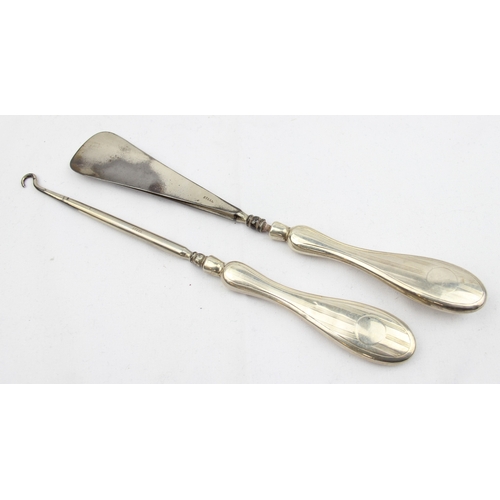 1013 - 4 silver backed brushes, a partial silver backed mirror and a silver mounted shoe and button hook, m... 