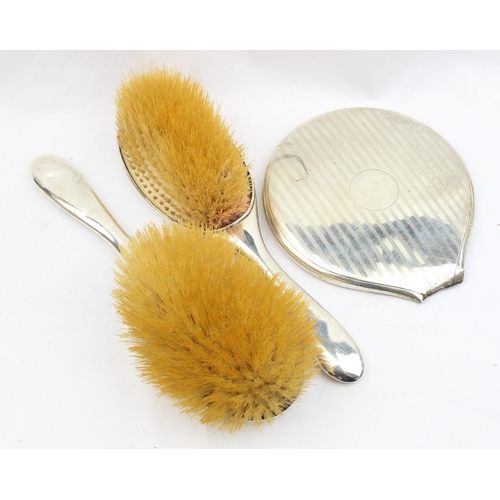 1013 - 4 silver backed brushes, a partial silver backed mirror and a silver mounted shoe and button hook, m... 