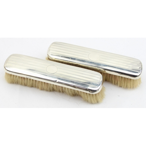 1013 - 4 silver backed brushes, a partial silver backed mirror and a silver mounted shoe and button hook, m... 