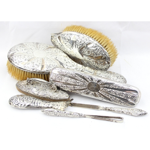 1059 - 3 silver backed brushes, one with broken handle, a silver mounted nail buffer and a silver handles n... 