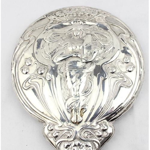 1072 - A silver mounted Art Nouveau designed hand mirror, depicting a female figure playing a harp, marked ... 