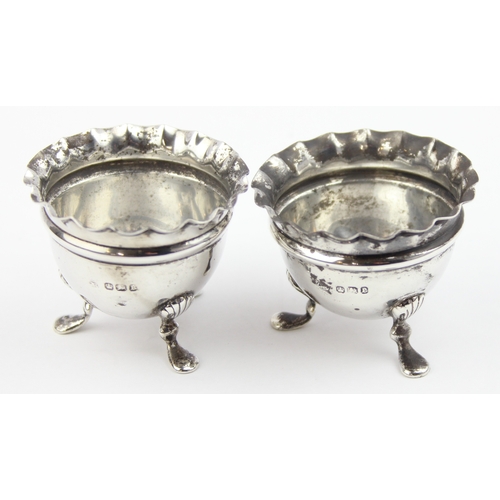 1075 - A pair of silver salts with ruffled rims and pad feet, marked for Sheffield 1897 by Joseph Rodgers, ... 