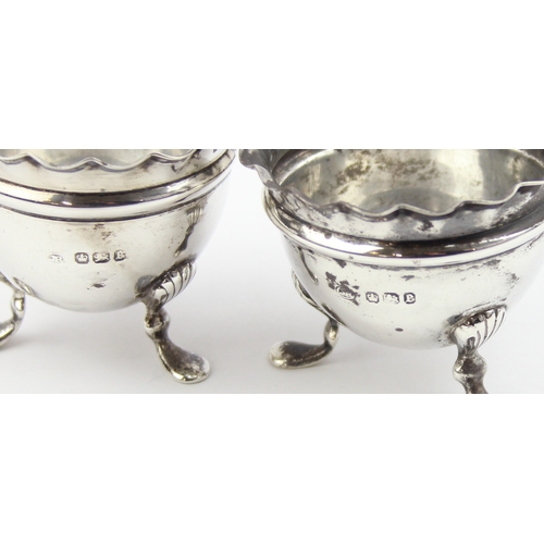 1075 - A pair of silver salts with ruffled rims and pad feet, marked for Sheffield 1897 by Joseph Rodgers, ... 