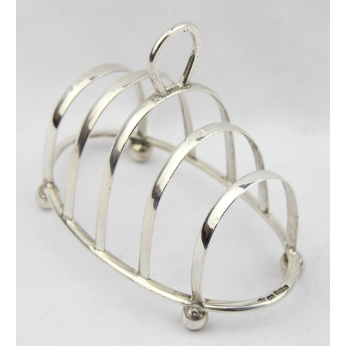 1082 - An early 20th century silver 4 slice toast rack, Sheffield 1912 by Joseph Rodgers, approx 57.97g gro... 