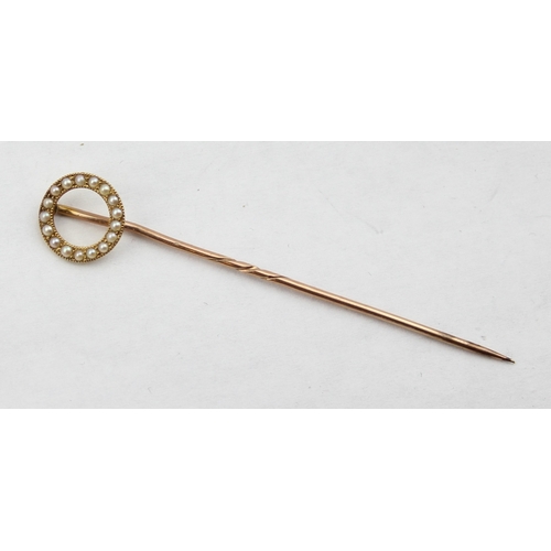 1101 - A 19th century 15ct gold stick pin set with seed pearls in a circular setting, the pin 9ct gold, unm... 