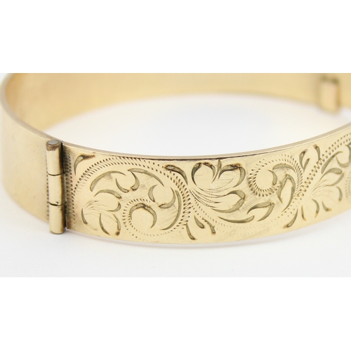 1118 - A vintage rolled gold bangle with engraved decoration, marked B Ltd 50 Micron 9ct RG Pat No 1167637,... 