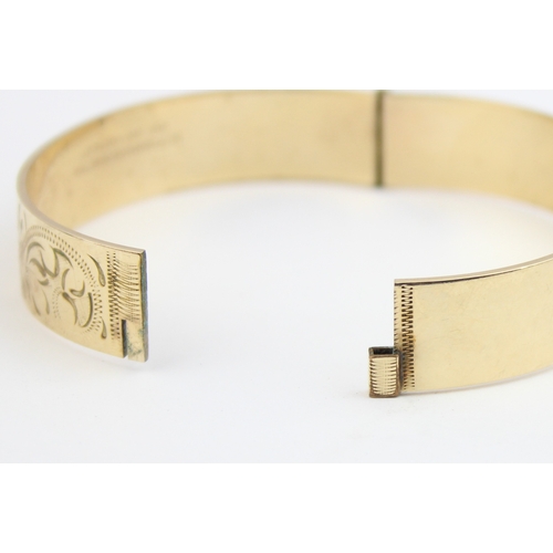 1118 - A vintage rolled gold bangle with engraved decoration, marked B Ltd 50 Micron 9ct RG Pat No 1167637,... 