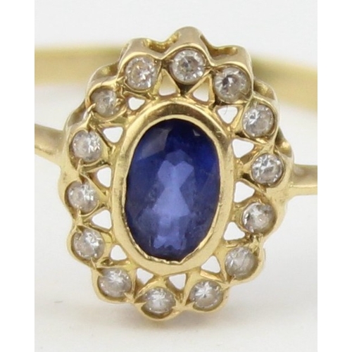 1136 - A vintage 18ct gold, sapphire and white stone ring, a large central blue sapphire surrounded by smal... 