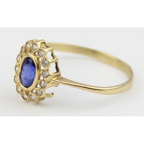 1136 - A vintage 18ct gold, sapphire and white stone ring, a large central blue sapphire surrounded by smal... 