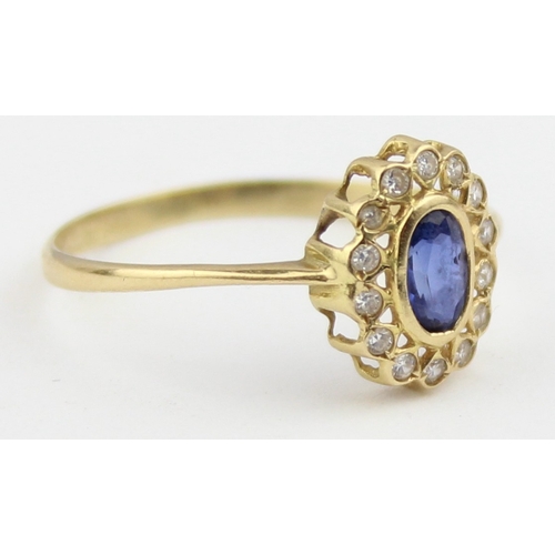 1136 - A vintage 18ct gold, sapphire and white stone ring, a large central blue sapphire surrounded by smal... 