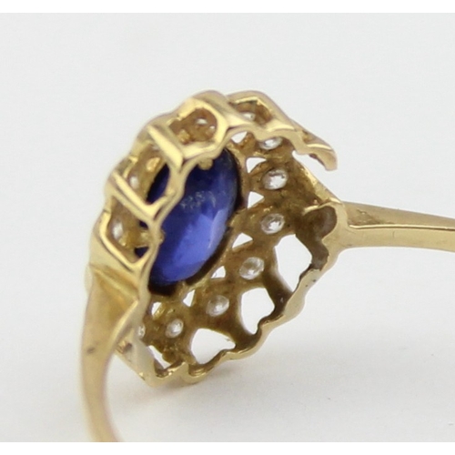 1136 - A vintage 18ct gold, sapphire and white stone ring, a large central blue sapphire surrounded by smal... 