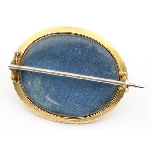 1137 - A Victorian 15ct gold brooch set with a facet cut red stone, possibly a Garnet, seemingly unmarked b... 