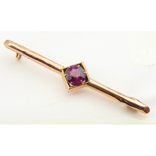 1140 - An antique 9ct gold and amethyst bar brooch, indistinctly marked and XRF confirmed, presented in per... 