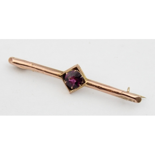 1140 - An antique 9ct gold and amethyst bar brooch, indistinctly marked and XRF confirmed, presented in per... 