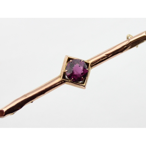 1140 - An antique 9ct gold and amethyst bar brooch, indistinctly marked and XRF confirmed, presented in per... 