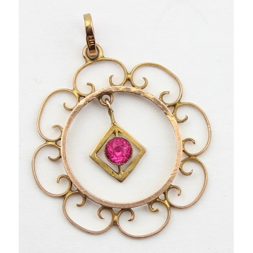 1147 - An Edwardian Art Nouveau 9ct gold pendant formed as a filigree flower with central pink stone, marke... 