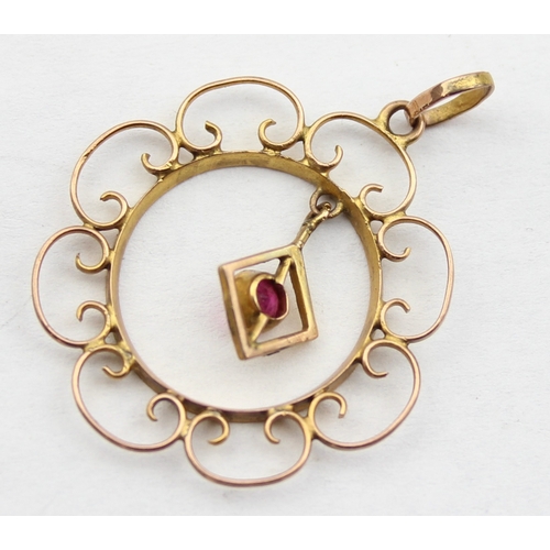 1147 - An Edwardian Art Nouveau 9ct gold pendant formed as a filigree flower with central pink stone, marke... 