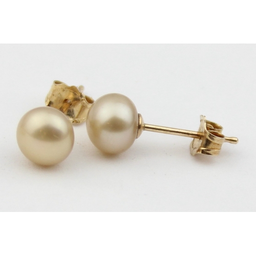 1148 - 2 pairs of 9ct gold mounted pearl stud earrings, all XRF confirmed, approx 1.66g gross