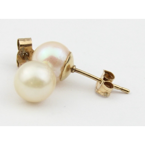 1148 - 2 pairs of 9ct gold mounted pearl stud earrings, all XRF confirmed, approx 1.66g gross