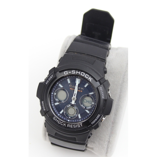 1318 - A Casio G-Shock AWG-M100SB watch with black plastic strap and some paperwork