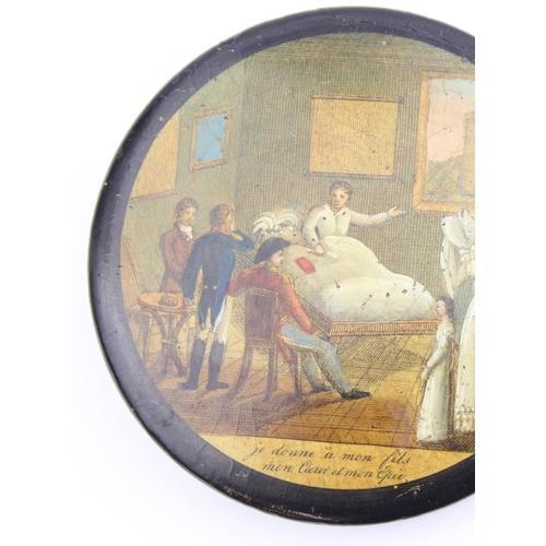 1451 - An early 19th century lacquered papier mache circular snuff box printed with a crowded tavern scene,... 