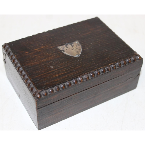 1222 - A small vintage oak box with silver shield plaque to top containing a large qty of assorted interest... 