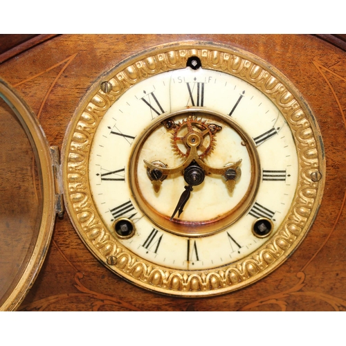 1342 - A vintage mahogany cased mantel clock with mechanical movement and inlaid case, key and pendulum, ap... 