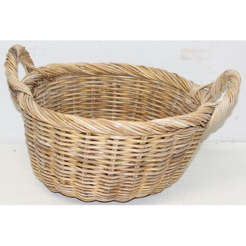 289 - A large vintage wicker basket with 2 handles and rounded base, approx 54cm wide