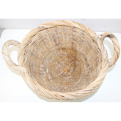 289 - A large vintage wicker basket with 2 handles and rounded base, approx 54cm wide