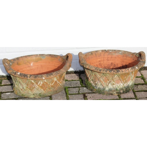 306 - A pair of weathered terracotta lattice designed garden basket planters with handles, each approx 43c... 