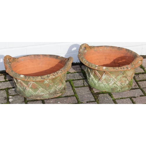 306 - A pair of weathered terracotta lattice designed garden basket planters with handles, each approx 43c... 