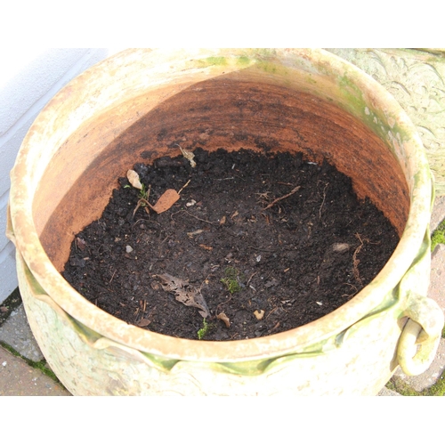 307 - A pair of weathered terracotta bulbous designed garden planters with ring handles, each approx 42cm ... 