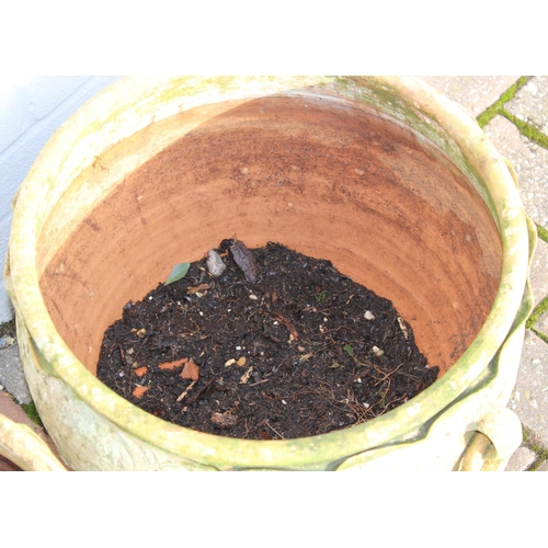 307 - A pair of weathered terracotta bulbous designed garden planters with ring handles, each approx 42cm ... 