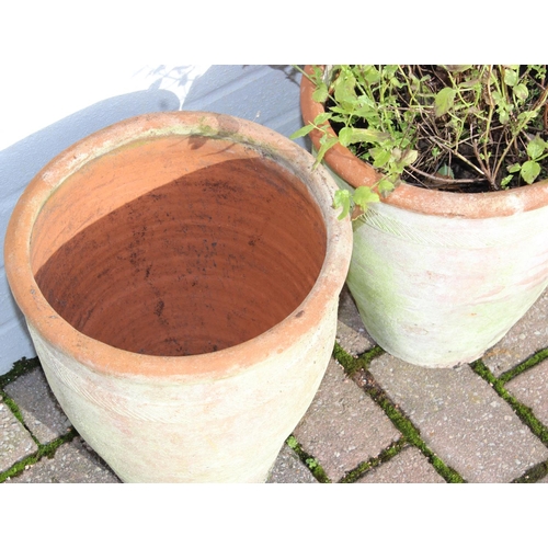 310 - A pair of weathered urn shaped terracotta garden planters, each approx 28cm in diameter x 31cm tall