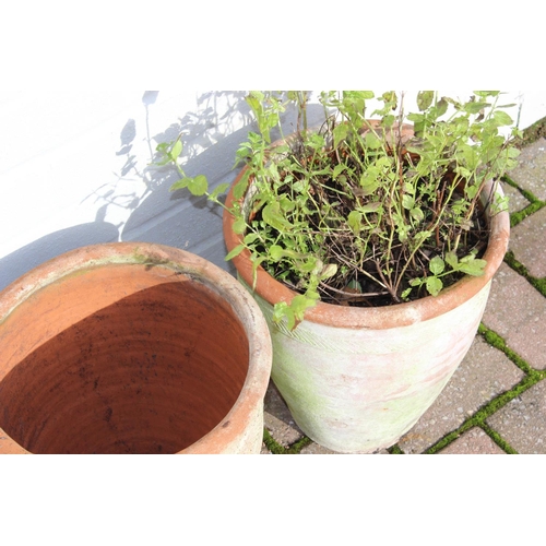 310 - A pair of weathered urn shaped terracotta garden planters, each approx 28cm in diameter x 31cm tall