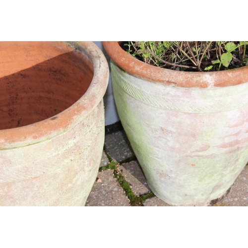 310 - A pair of weathered urn shaped terracotta garden planters, each approx 28cm in diameter x 31cm tall