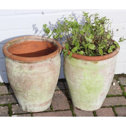 310 - A pair of weathered urn shaped terracotta garden planters, each approx 28cm in diameter x 31cm tall