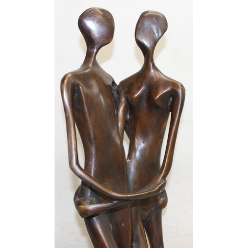 374B - A heavy bronzed metal sculpture of an embraced naked couple, seemingly unsigned, on marble base, mad... 