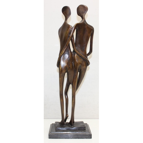 374B - A heavy bronzed metal sculpture of an embraced naked couple, seemingly unsigned, on marble base, mad... 