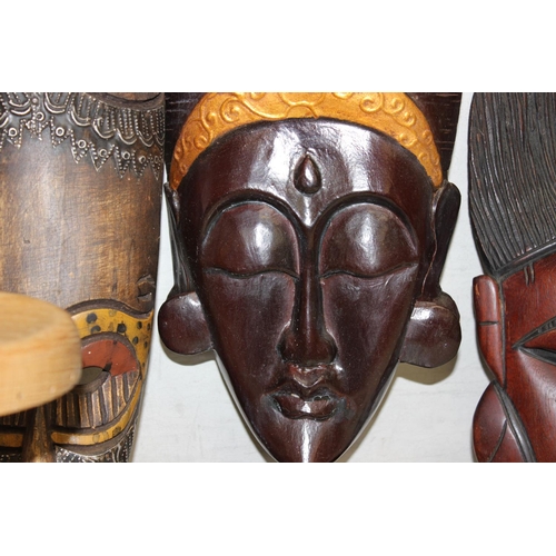 1586 - Qty of various African and other African style woodenware items to include facemasks and a set of 6 ... 