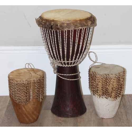 720A - 3 vintage goat skin drums to include a large Djembi drum, largest approx 63cm tall