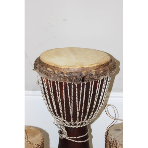 720A - 3 vintage goat skin drums to include a large Djembi drum, largest approx 63cm tall