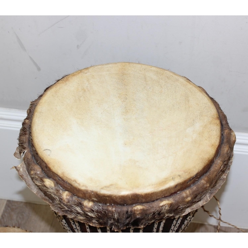 720A - 3 vintage goat skin drums to include a large Djembi drum, largest approx 63cm tall