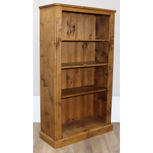 182 - A modern stained pine adjustable bookcase with 3 adjustable shelves, approx 81cm wide x 32cm deep x ... 