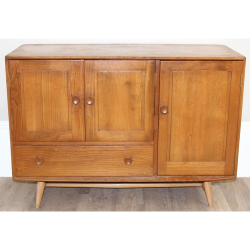 22 - A retro Ercol 3 door single drawer sideboard, believed to be a model 467, on splayed legs, approx 11... 