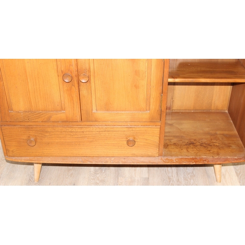 22 - A retro Ercol 3 door single drawer sideboard, believed to be a model 467, on splayed legs, approx 11... 