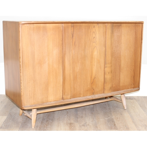 22 - A retro Ercol 3 door single drawer sideboard, believed to be a model 467, on splayed legs, approx 11... 