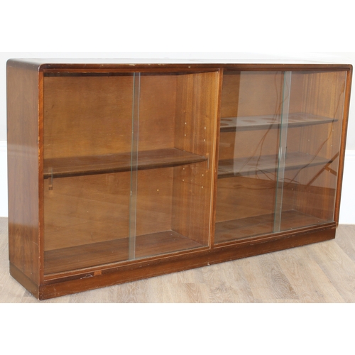 37 - A mid-century retro glazed 2 door bookcase, seemingly unmarked, approx 136cm wide x 27cm deep x 75cm... 